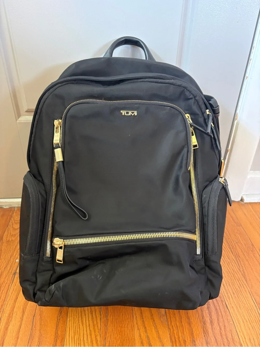 Tumi Voyageur Celina Black Backpack with Gold Hardware and Multiple Zip Pockets